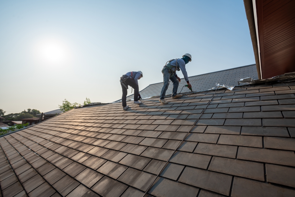 Roofers from a licensed roofing company installing a new roof on a St. Louis home