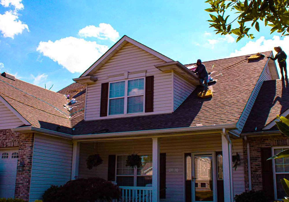 Roofers working on a residential roof in St. Louis